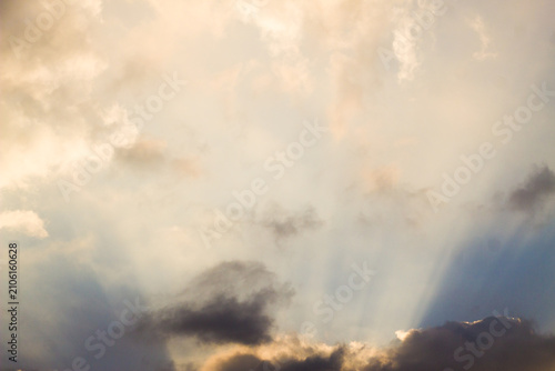 Photos Beautiful crepuscular sun rays breaking through dramatic clouds at sunset sky