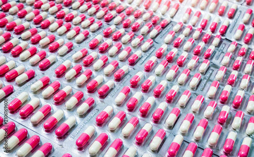 Fotografie Closeup pink-white antibiotic capsule pills in blister pack