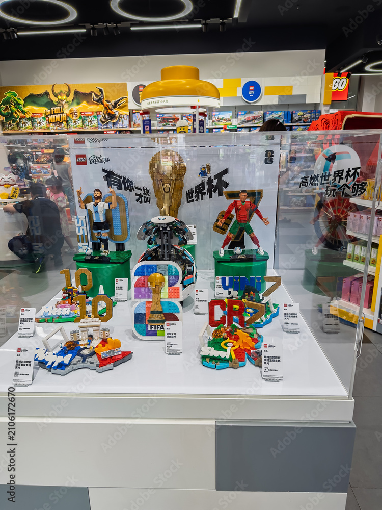 Fototapeta premium Display case at LEGO store featuring FIFA World Cup brick figures of Messi and Ronaldo with trophy in Shanghai, China - May 25, 2026