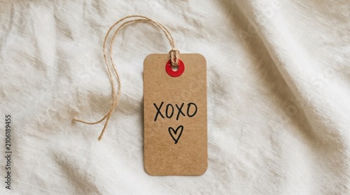 Kraft tag with handwritten 'xoxo' and heart flat lay composition