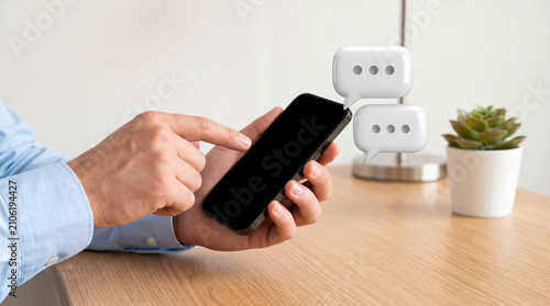 Hands holding a smartphone with blank screen and 3D chat bubbles floating above. Texting, social media, and digital communication