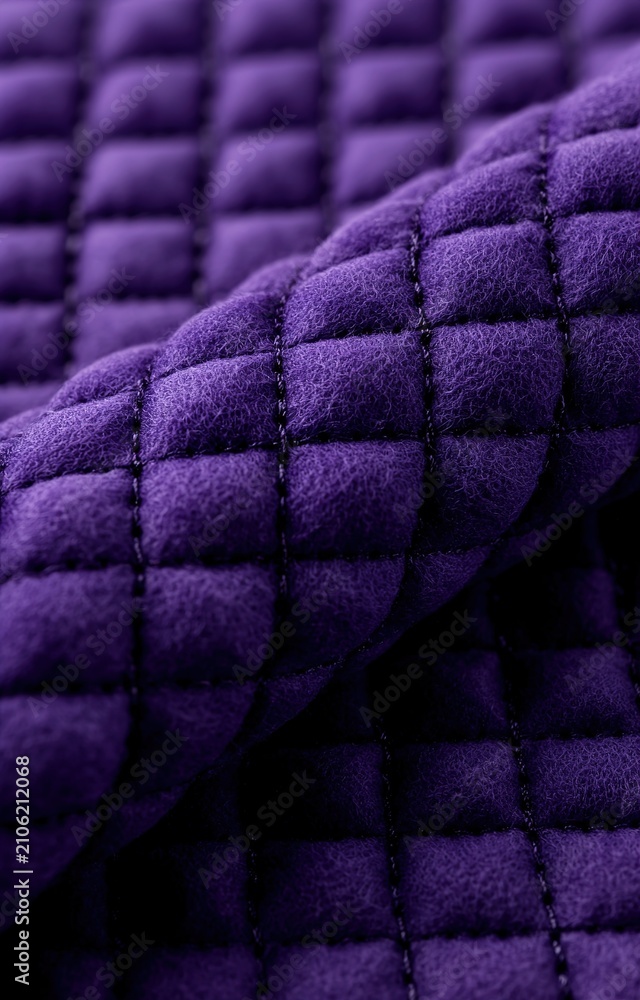 Obraz premium A close-up view of a vibrant purple quilted fabric with a soft texture