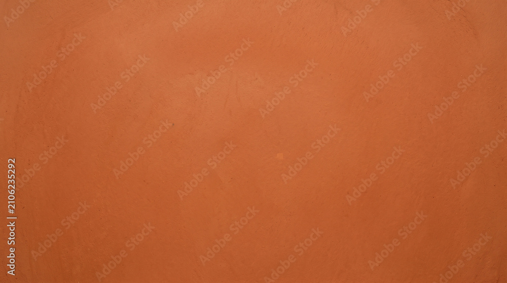 Fototapeta premium Burnt orange smooth plaster wall texture background for bold interior design