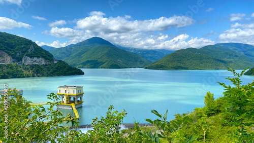 Fotografie Zhinvali Reservoir stores mountain water beside a dam intake tower in Georgia, s