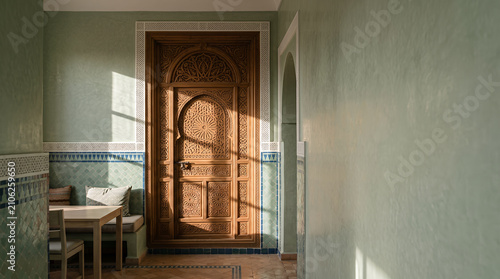 Ornate carved wooden door in a traditional Moroccan interior hallway