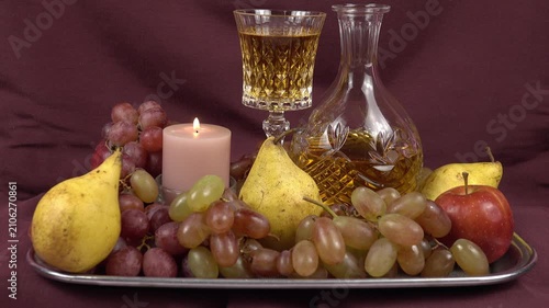 Classic Still Life Composition with Fresh Fruits, Lit Candle, Crystal Decanter and Wine Glass on Vintage Tray
