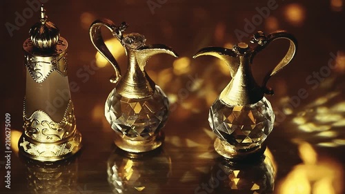Luxurious Arabian Attar Perfume Bottles and Crystal Flasks with Warm Golden Bokeh Lighting