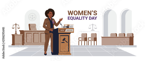 Woman speaks at podium in courtroom for Women's Equality Day
