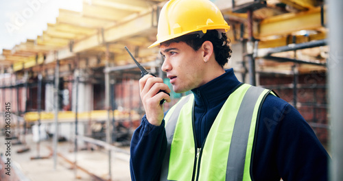 Obraz na płótnie Radio, engineer and talk with man on construction site for building inspection, contact and feedback