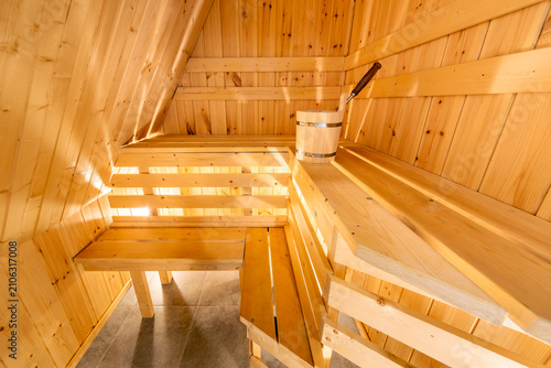  Interior of a traditional wooden Finnish sauna or Russian banya with benches and a bucket in Karelia, Russia
