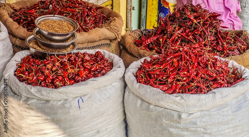 Cuadro en lienzo Piles of dried red chilies in large sacks at a traditional Indian market, showca