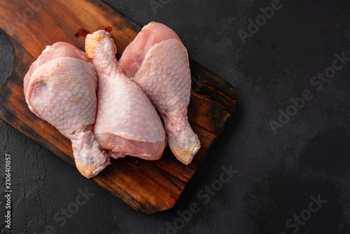 Raw chicken leg or drumstick isolated on black  background 