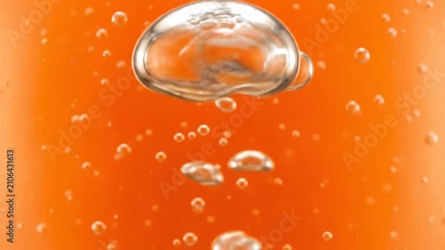 Clear bubbles rising through a vibrant orange liquid background
