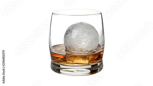 Glass tumbler filled with ice cubes and amber liquor isolated on transparent background