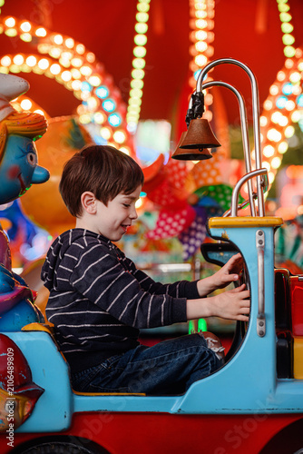 Elevated portrait boy in red flying car eye contact framed by helicopter dusk