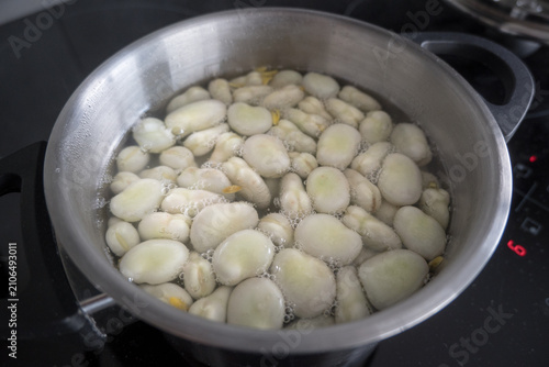 Broad beans cooking in a pot.
