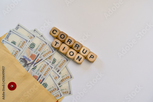 фотографія Corruption word on wooden blocks with cash