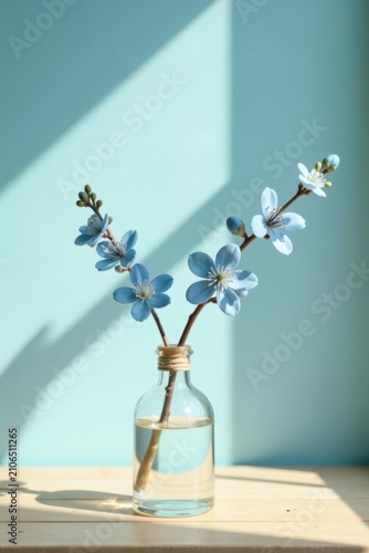 Serene Light Blue Flowers in a Glass Vase on a Wooden Surface