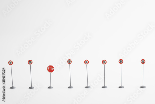 Miniature speed limit signs on white background
