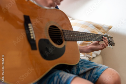 Fotografie Acoustic guitar playing at home