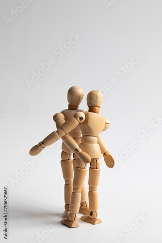 wo wooden figures hugging each other