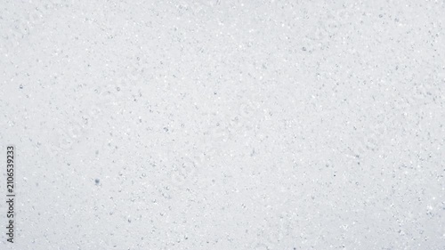 Abstract close up of falling water droplets creating dynamic splashes and bubbles. Refreshing rainfall or tropical shower background with fluid motion and natural texture