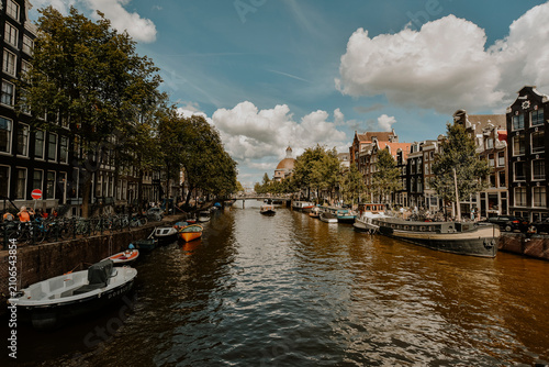 Netherlands, North Holland, Amsterdam, City canal with rows of moored boats on each side