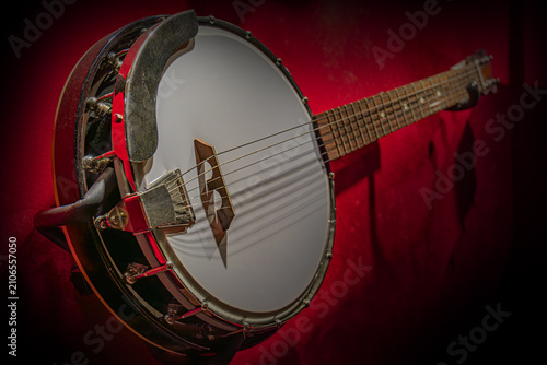 Dark Wood Banjo Against Rich Red Background