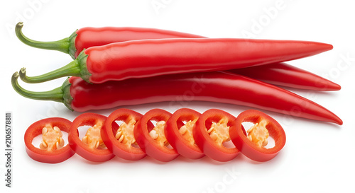 A fresh red chili peppers presented whole and sliced, isolated on a pure white background