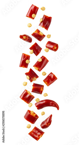 Chopped dried red chili pieces suspended in a floating composition, isolated on a pure white background