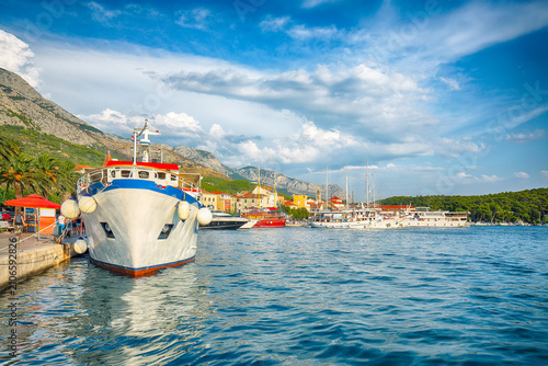 Amazing Adriatic resort Makarska with picturesque harbor and touristic boats.
