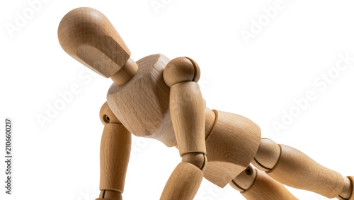 Fotografie Isolated wooden art mannequin showing effort in a dynamic push-up or crawling mo