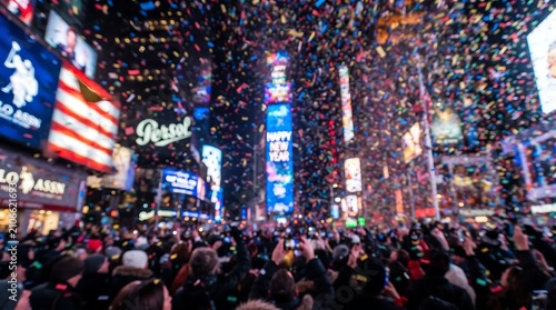 Crowd celebrating new year in Times Square with colorful confetti falling over the city
