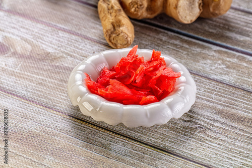 Fotografie Japanese pickled ginger gari in small dish with fresh root on wood