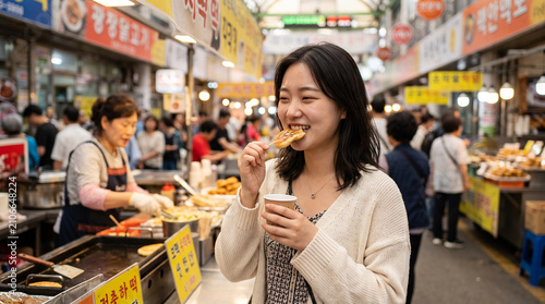 Young woman eating street food at a korean market for travel background and cultural food banner photography