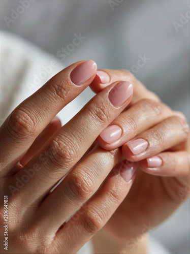 Close-up of a nail technician's hands with manicured nails