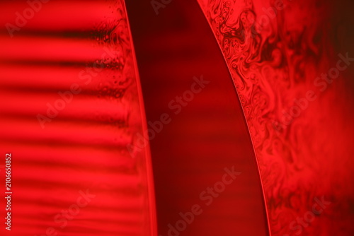 Crimson monochrome fluid macro with striped waves and turbulent currents. Atmospheric horizontal macro footage of a deep red liquid surface.