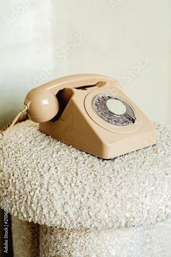 old fashioned beige phone on the beige sofa 