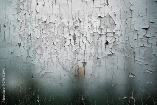 Peeling white paint texture on weathered wall background