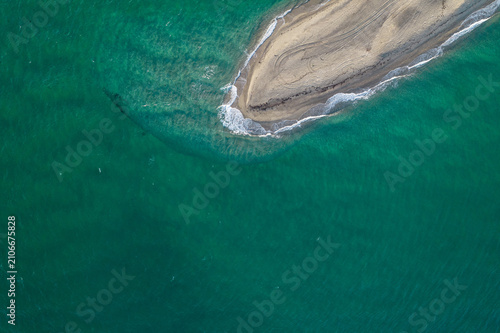 Aerial view of Possidi cape and narrow strip of land wild white sand beach in the Aegean. Sea with turquoise water. Kassandra, Halkidiki, Greece