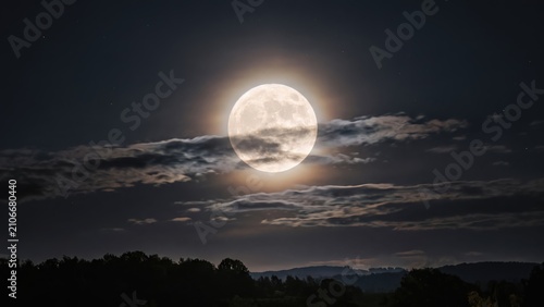 Full Moon Over Silhouetted Forest