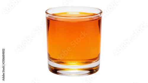Isolated clear glass of refreshing orange-colored beverage, fruit juice, or summer drink