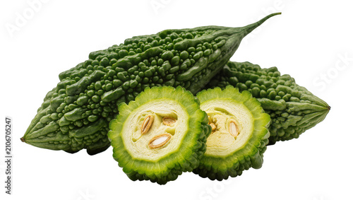 Cuadro en lienzo Isolated fresh vibrant green bitter gourds with a sliced piece revealing seeds a