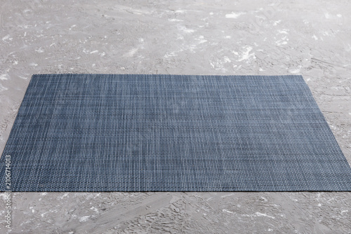 Perspective view of grey tablecloth for food on cement background. Empty space for your design