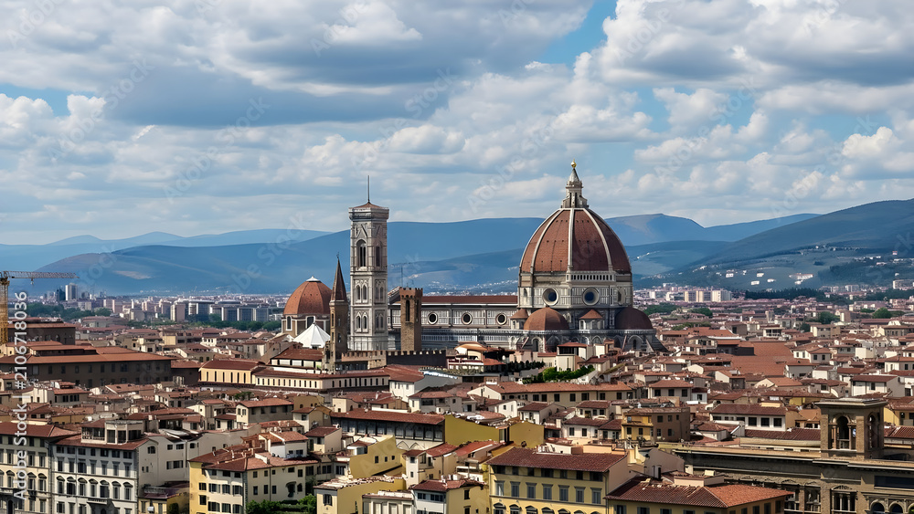 Fototapeta premium Panoramic view of the historic Renaissance cityscape featuring the iconic terracotta dome and medieval bell tower under a bright blue summer sky