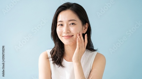 Portrait of a Young Beautiful Asian Woman with Healthy Glowing Skin Touching Her Cheek for Skincare Concept