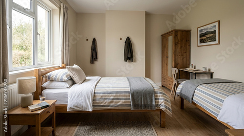 Cozy bedroom with twin beds, wooden furniture, natural light, and rustic charm.