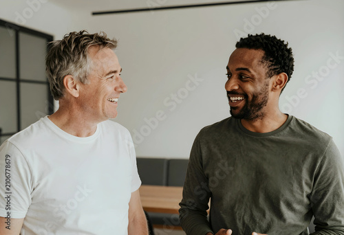 Two diverse men smiling and...