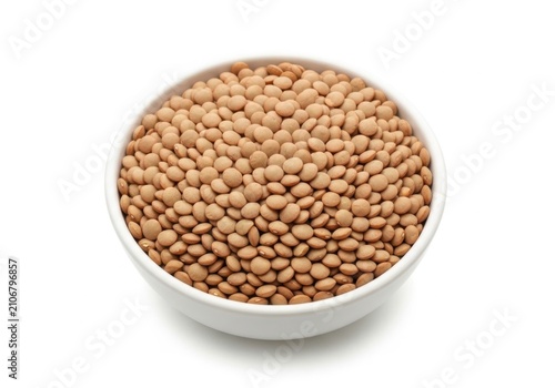 A small white bowl filled with dry brown lentils for healthy cooking and nutrition on a plain surface