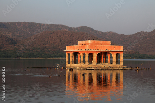 Jal Mahal reflected in the tranquil waters of Man Sagar Lake during golden hour in Jaipur, Rajasthan, India